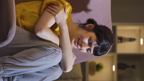 Vertical-video-of-Sad-young-woman-crying-at-home.